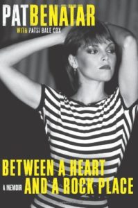 Cover of Between A Heart and A Rock Place. 1980s photo of Pat Benatar, wearing a black and white striped t-shirt.