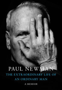 Book cover of Extraordinary Life of an Ordinary Man. Head and shoulders photo of Paul Newman, with one hand covering half his face.