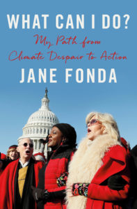 Cover of What Can I Do? Photo of Jane Fonda amid a group of protesters, all in red coats, with the nation's capital in the background.